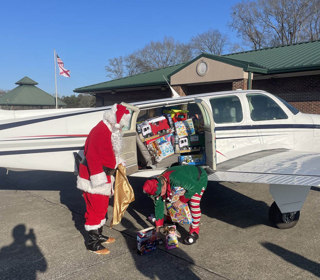 Santa and Elf Unloading Toys For Toy Drive