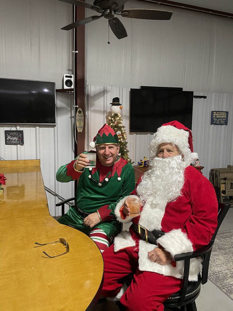 Santa and Elf Having A Knock After Flying In Toys For Christmas Toy Drive